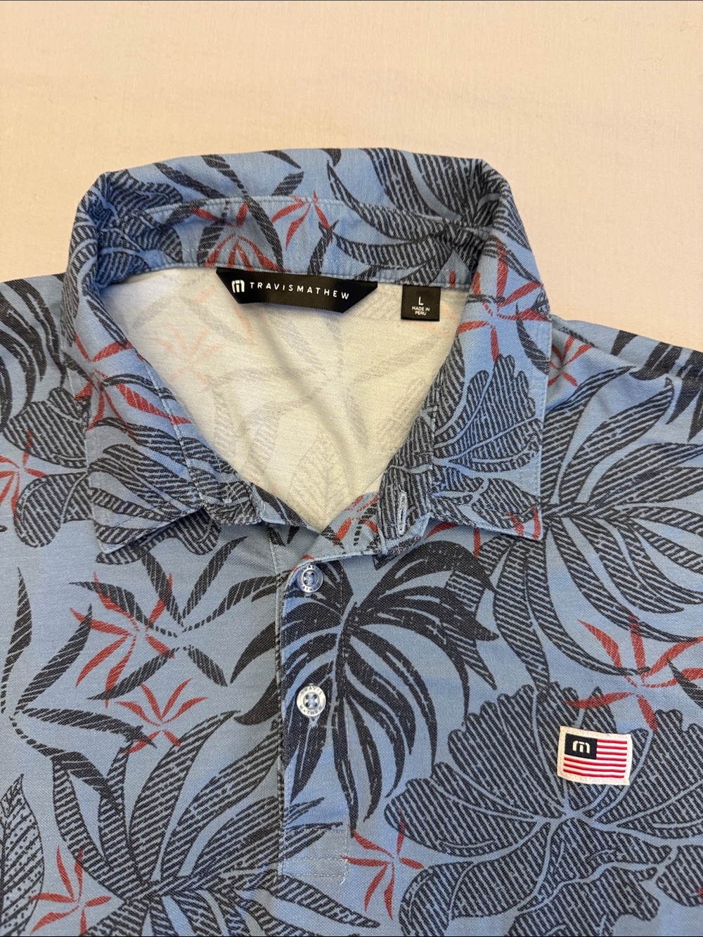Travis Mathew golf shirt Light Blue Tropical Leaf Print Polo with Red Accents